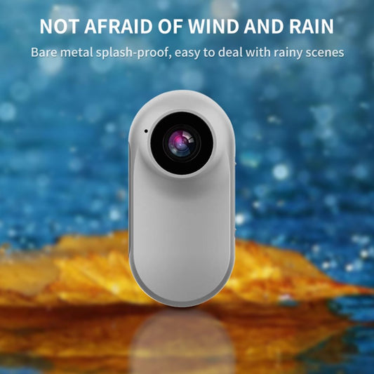 Mini-Motion View action camera, splash-proof metal body shown against water - waterproof mini HD camera for rain and outdoor use