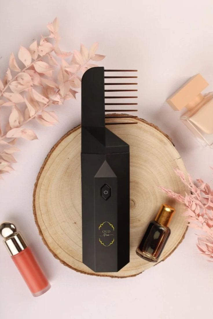 Woman perfuming her hair with the electric bakhoor comb