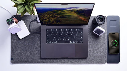 Grey 4-in-1 wireless charging desk mat with laptop, smartphone charging and smartwatch on a tidy home office desk